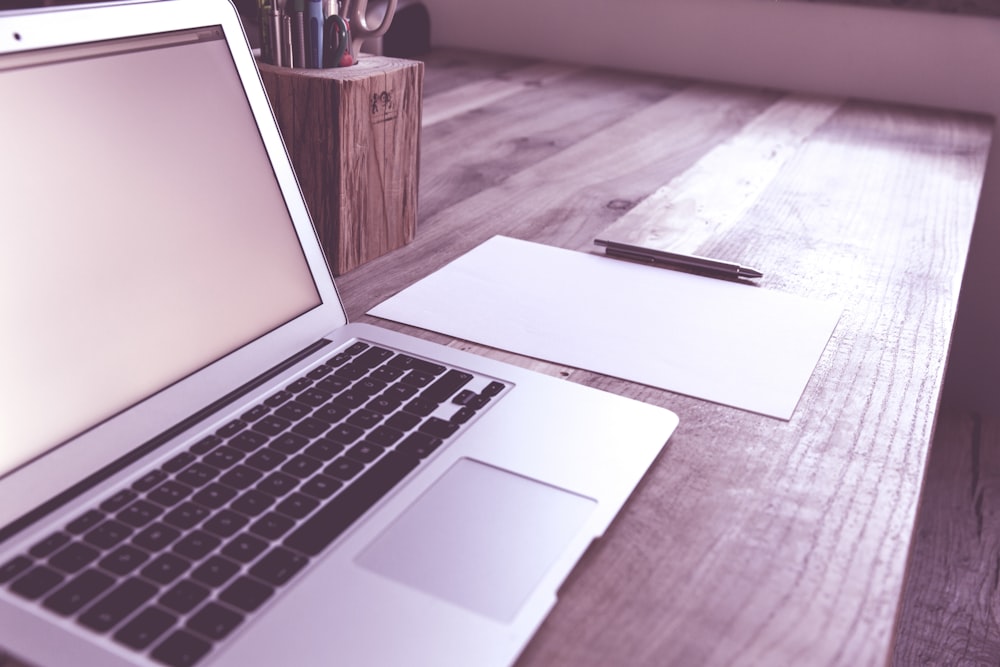 macbook air on brown wooden table