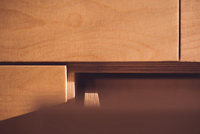 Various plywood panels displayed with visible wood grains and textures under natural light.