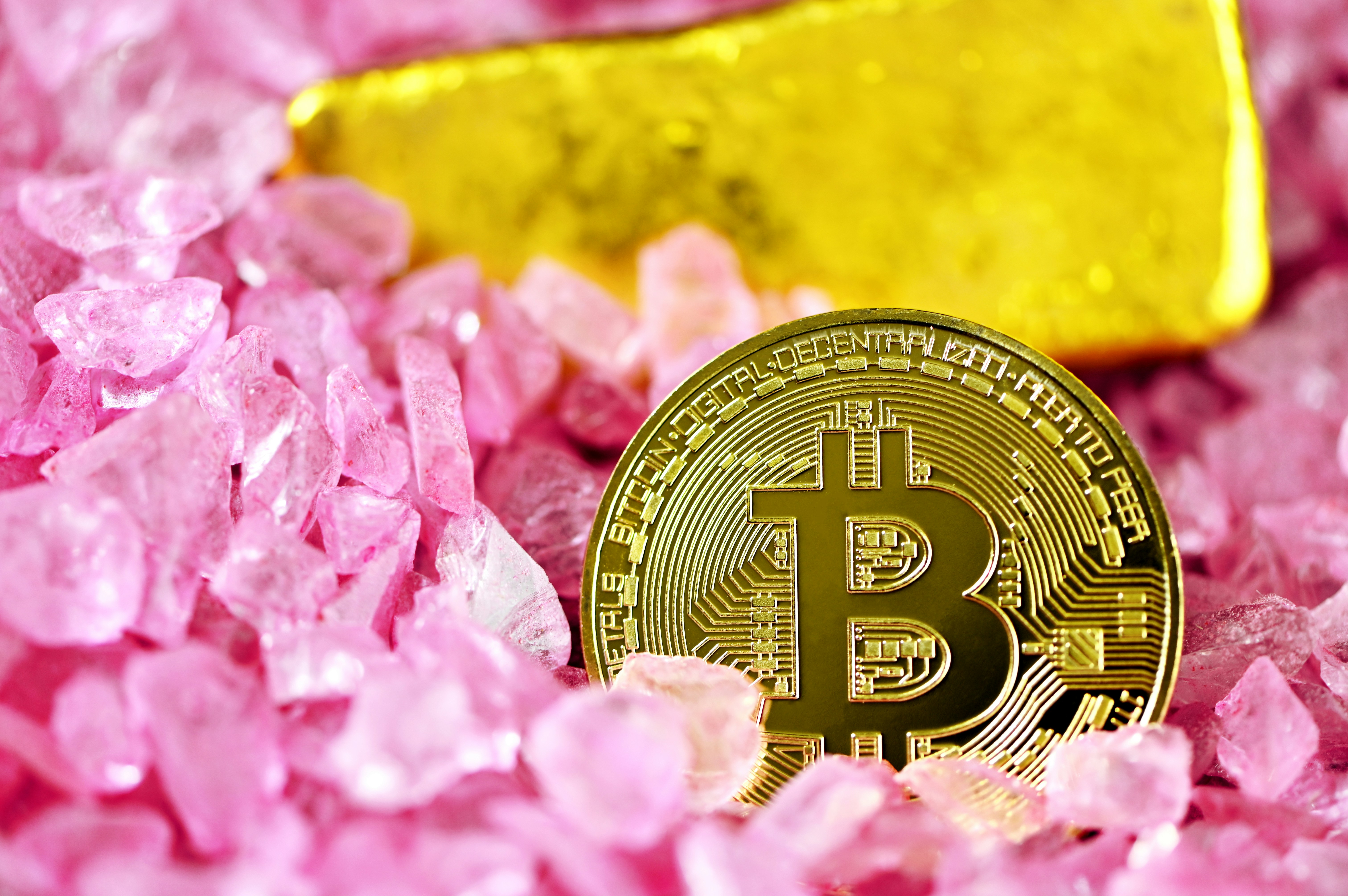 Bitcoin with gold and pink crystals