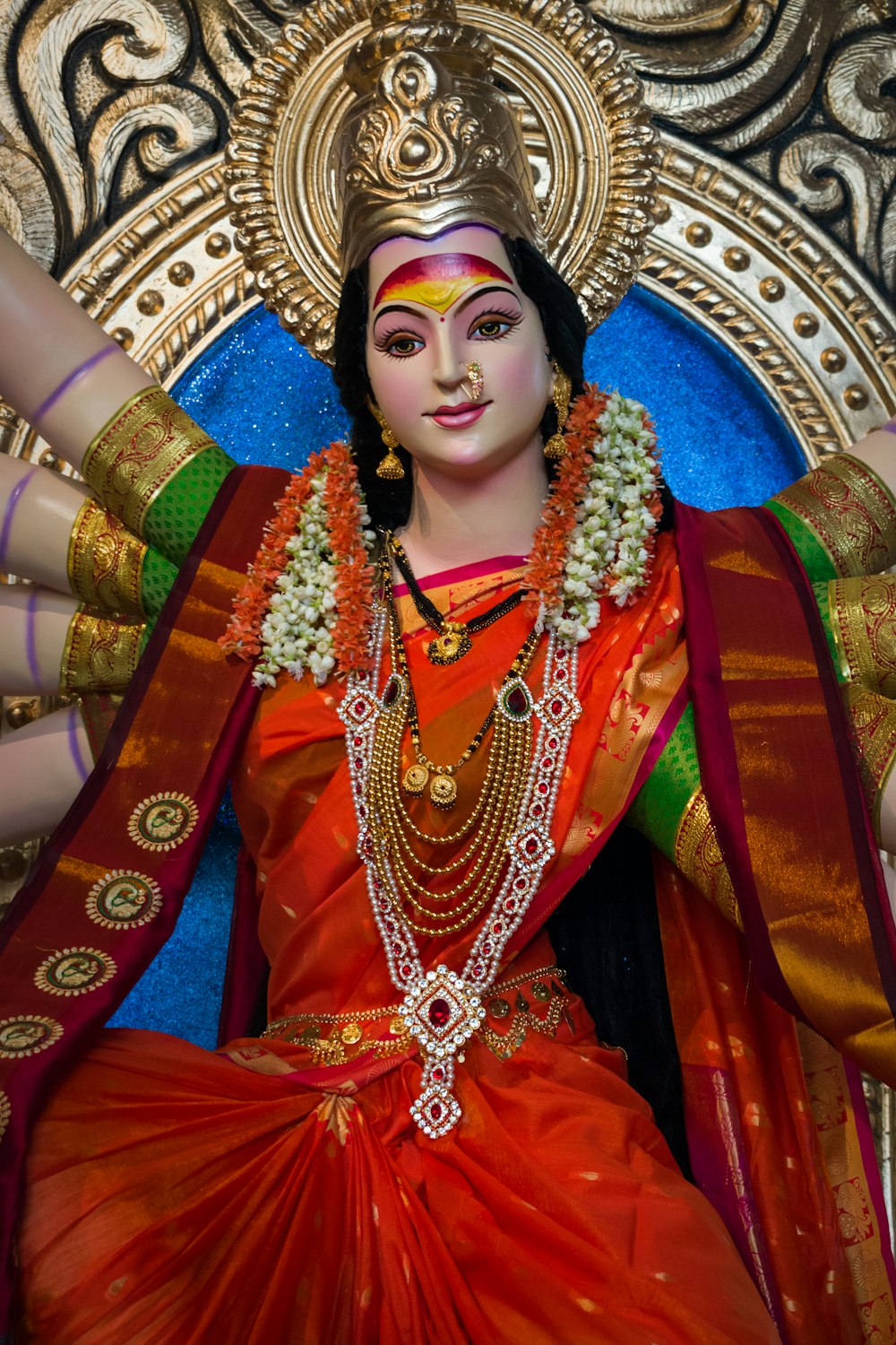 woman in red and gold sari