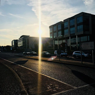 A photographer capturing urban street scenes during golden hour.