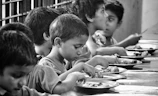 boy and girl eating on table