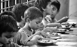 boy and girl eating on table