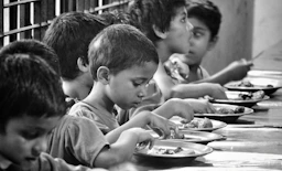boy and girl eating on table