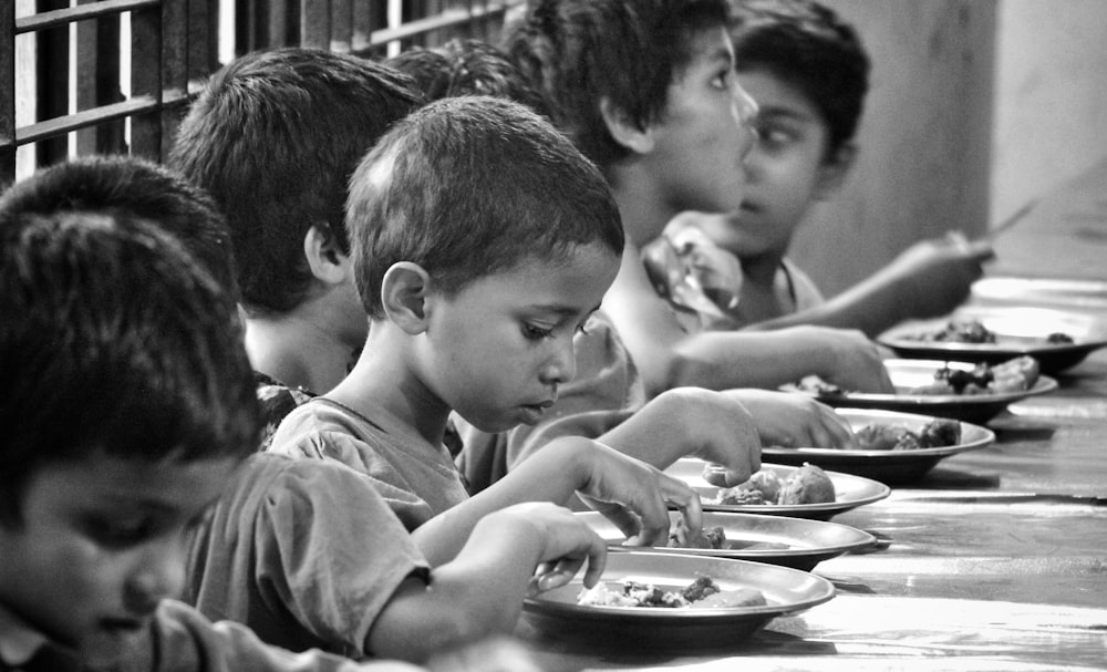 boy and girl eating on table