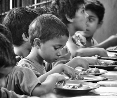 boy and girl eating on table