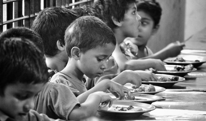 boy and girl eating on table