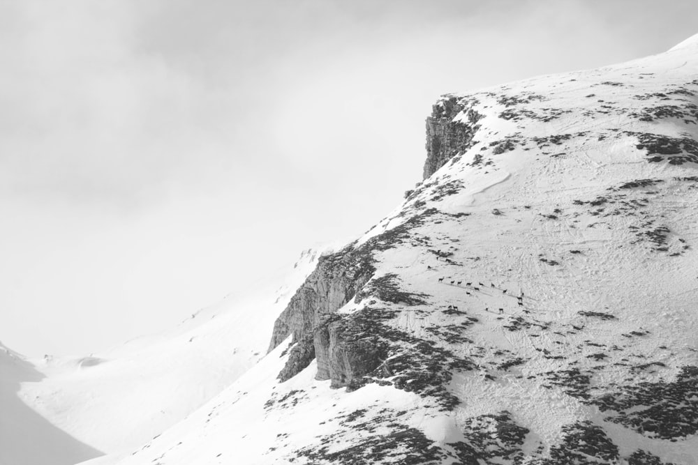 snow covered mountain under cloudy sky during daytime