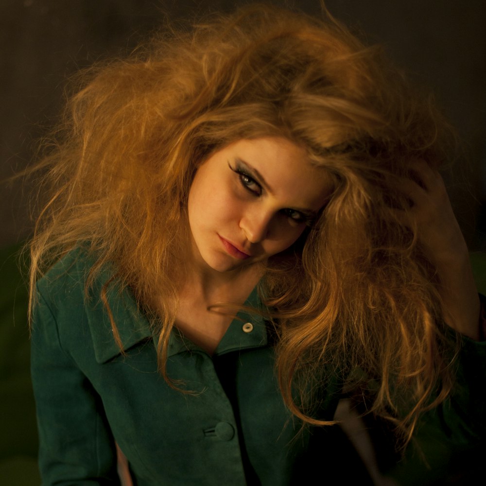 woman in green button up shirt wearing black framed eyeglasses