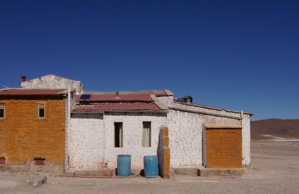 white and brown concrete house under blue sky during daytime