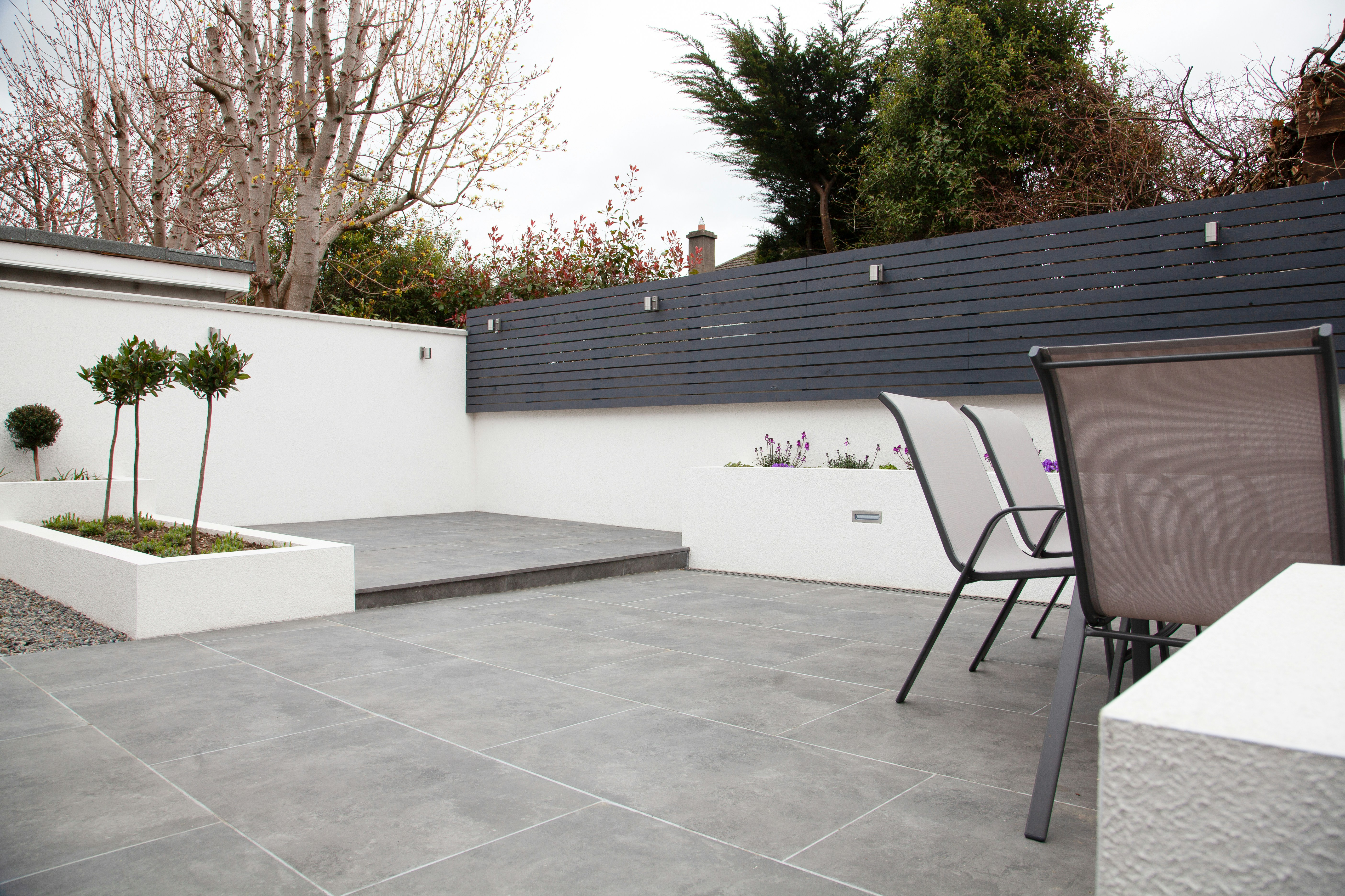 Exterior view showcasing freshly tiled patio with clean lines and contemporary design.