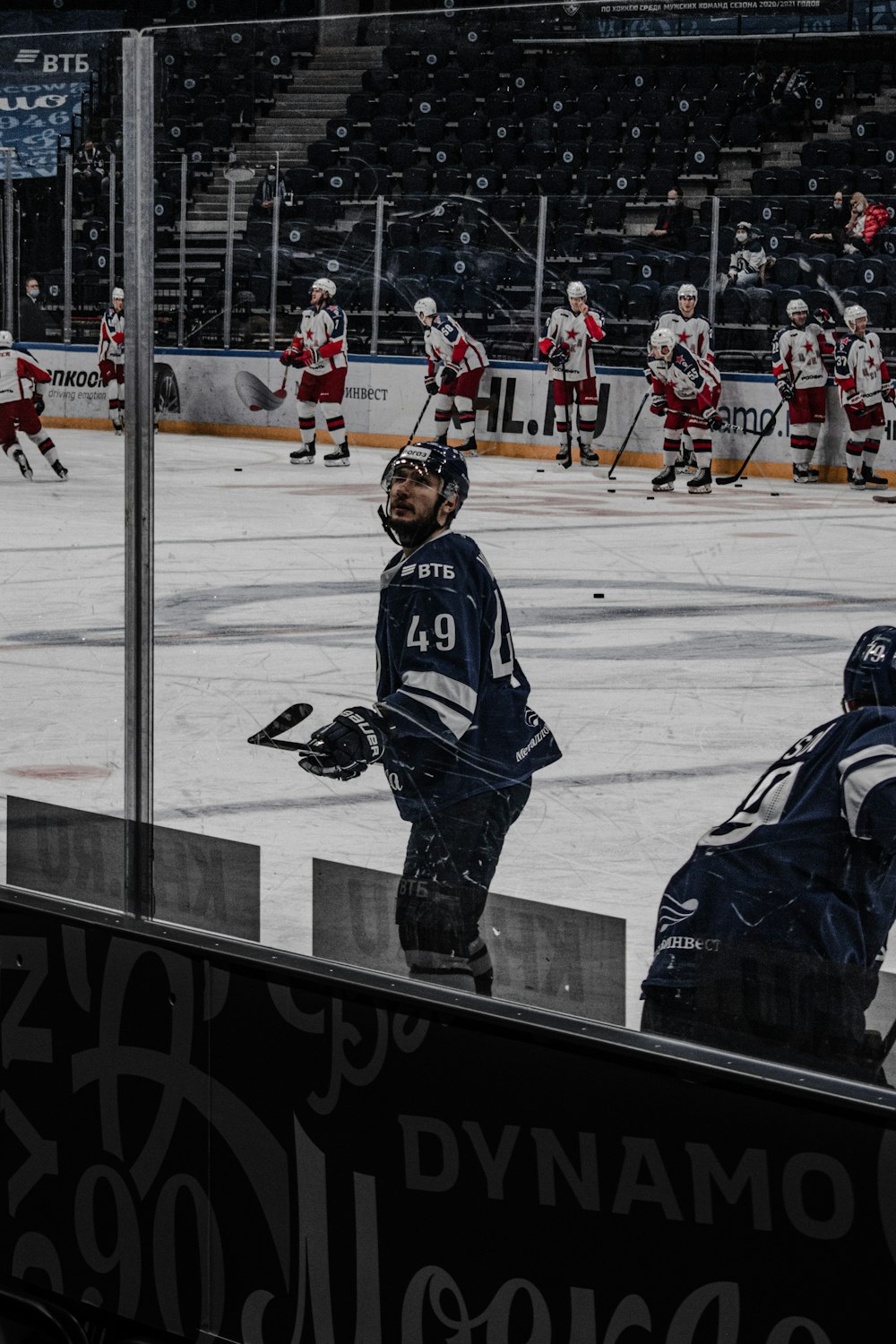 man in black ice hockey jersey standing on ice hockey field