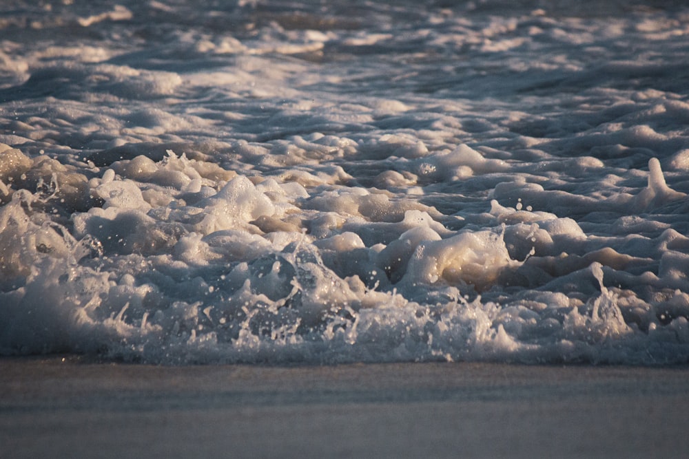 white ice on body of water during daytime