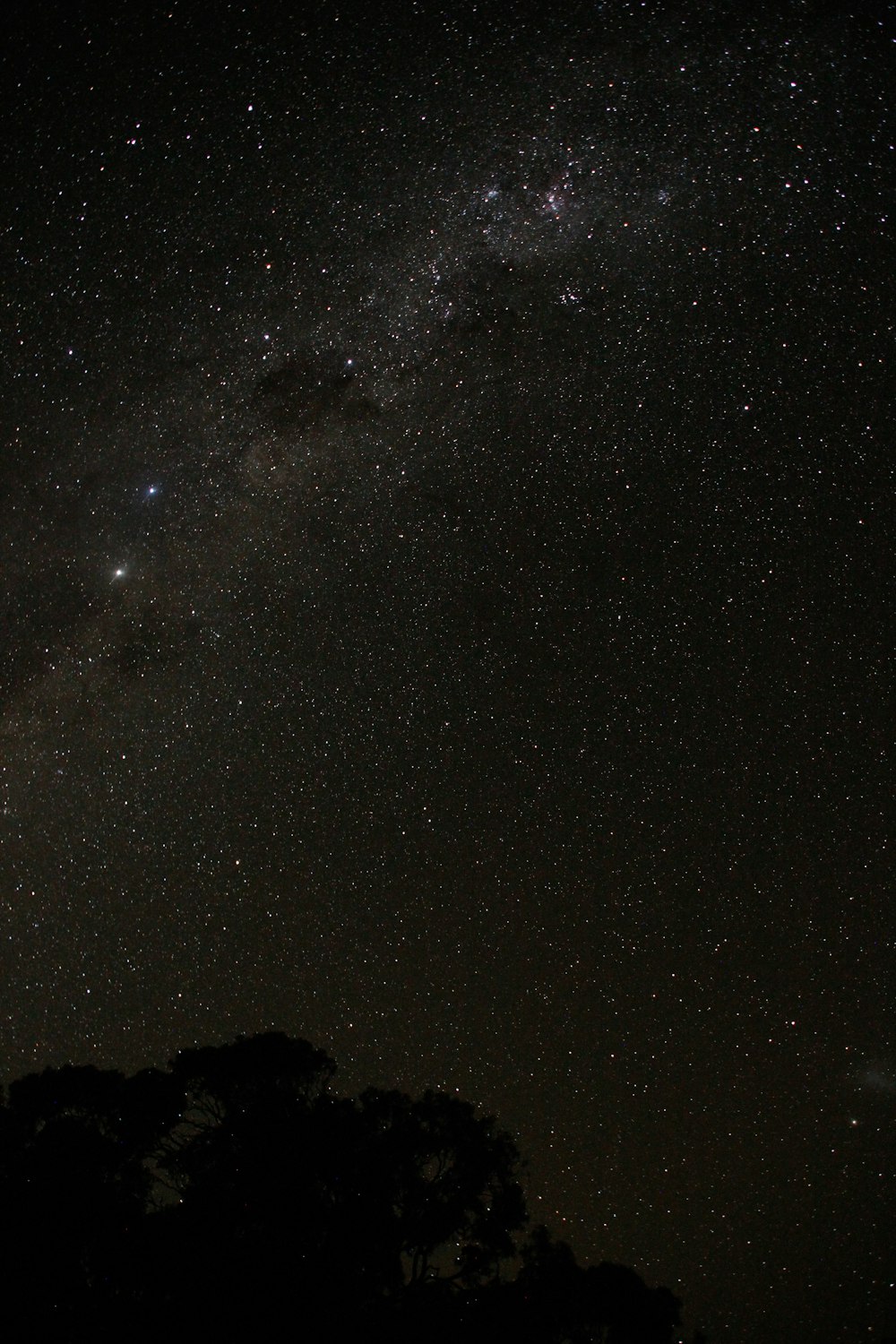 starry night over the silhouette of mountain