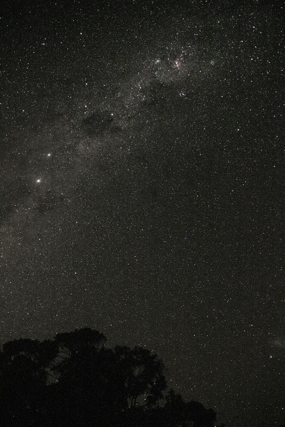 silhouette of mountain under starry night