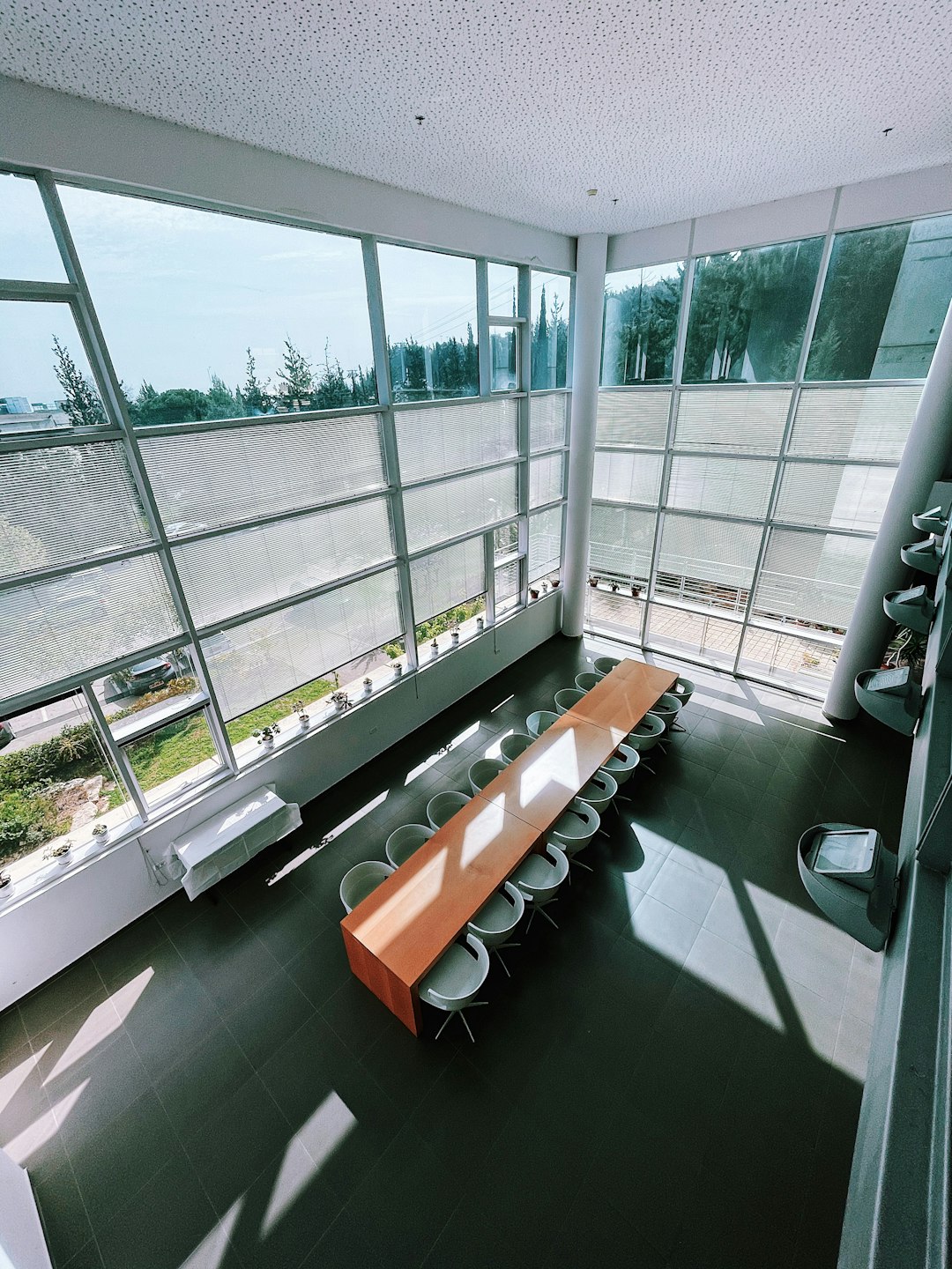 brown wooden bench near glass window