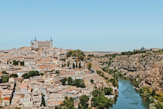 white and brown concrete buildings near body of water during daytime