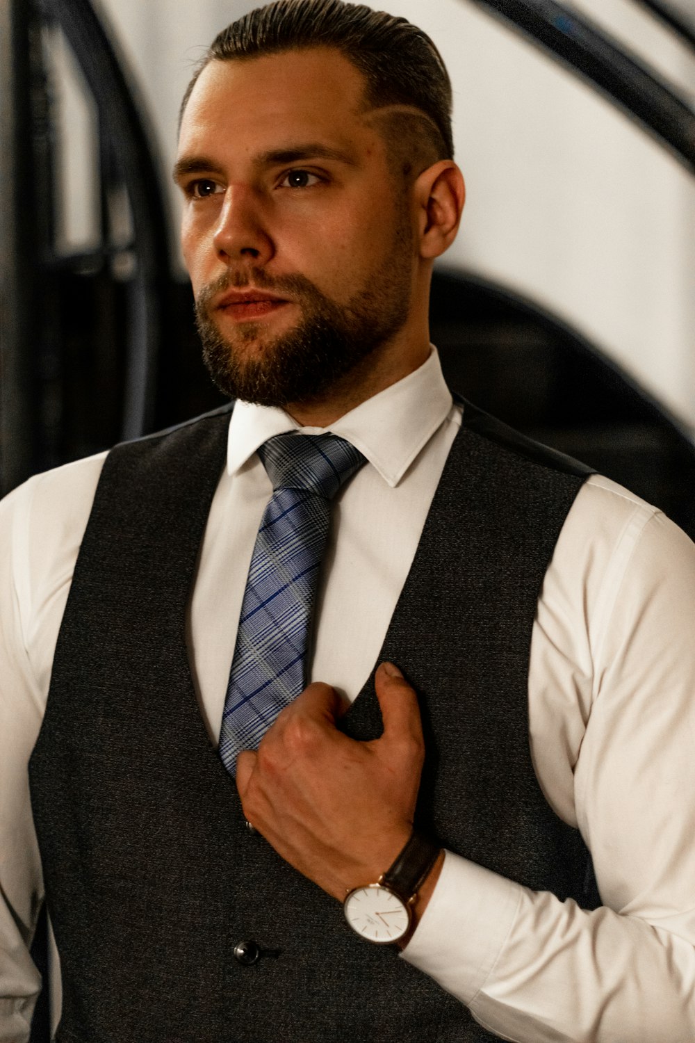 man in white dress shirt and black vest