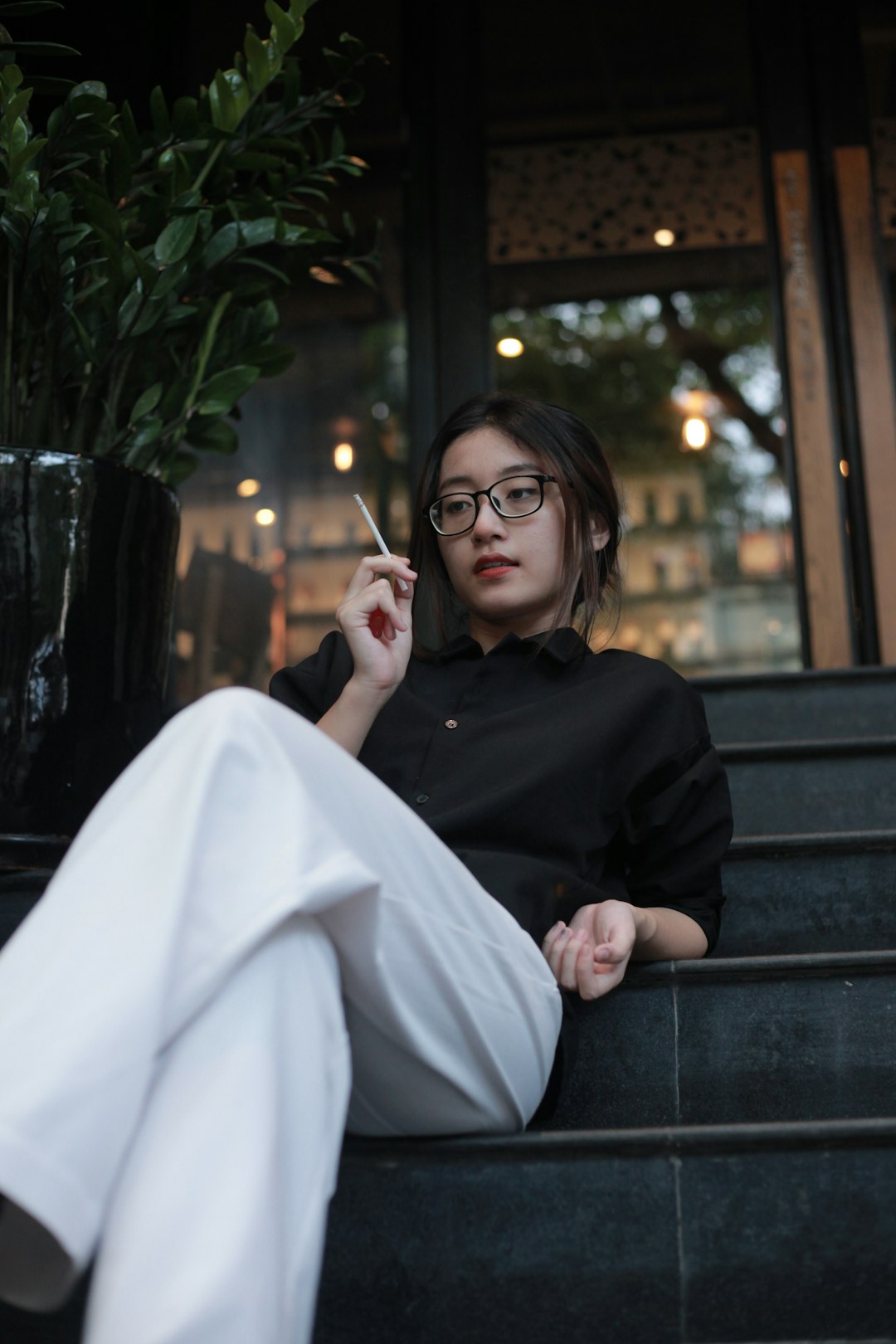 woman in black long sleeve shirt sitting on bench