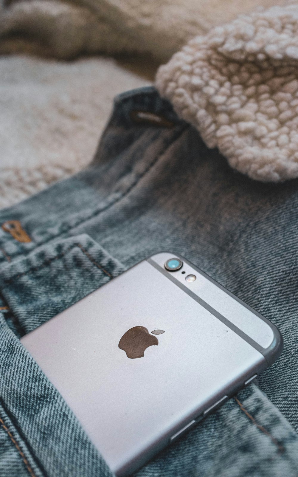 silver iphone 6 on blue denim jeans