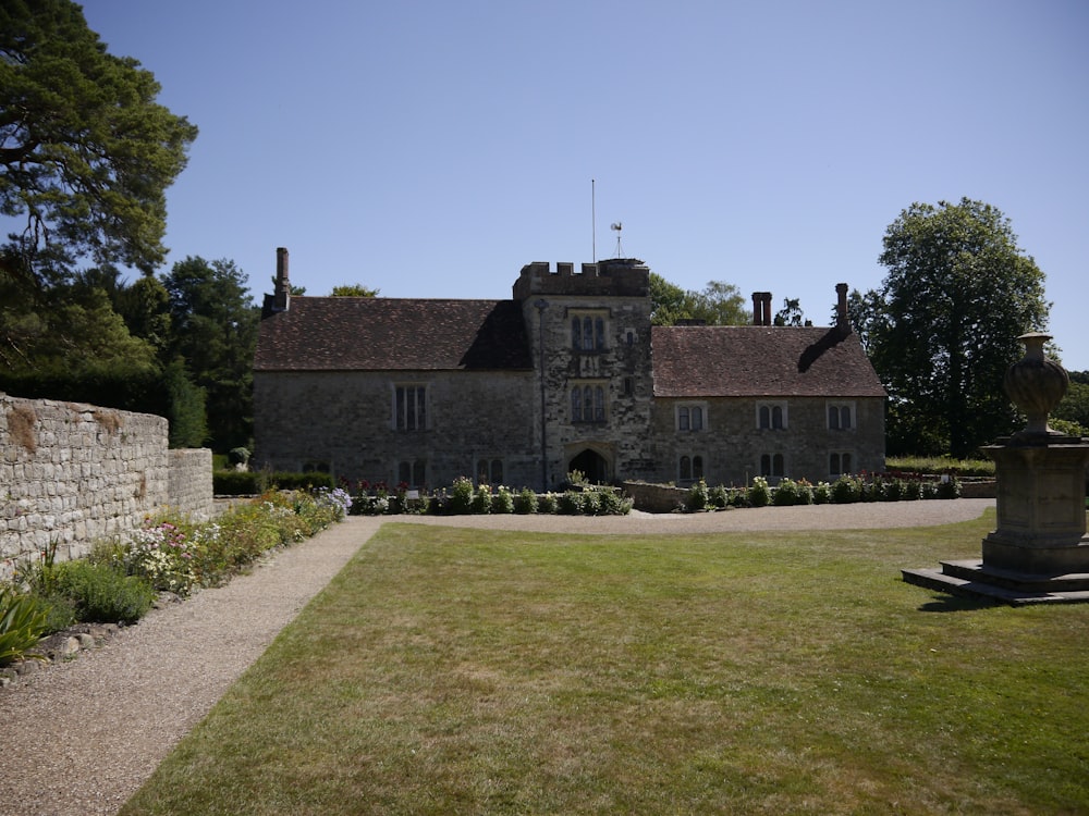 brown brick building with green grass lawn