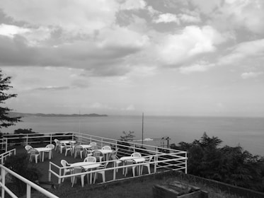 The hostel’s inviting outdoor patio overlooking lush greenery and the ocean beyond.