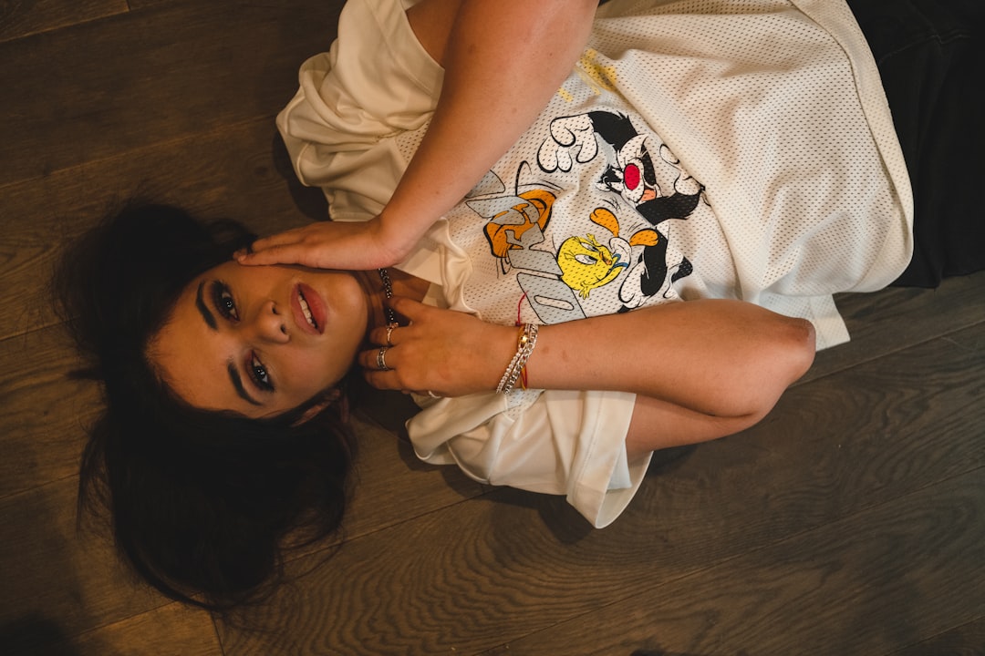 girl in white t-shirt lying on bed