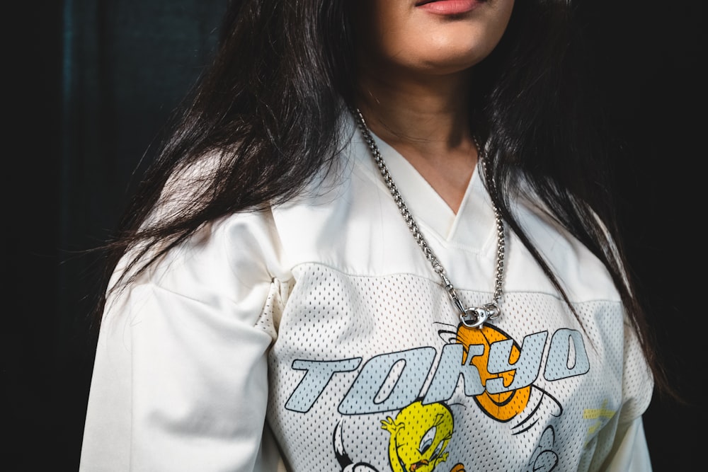 woman in white and yellow cat print collared shirt