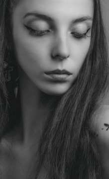 Realistic portrait tattoo of a woman with soft shading.