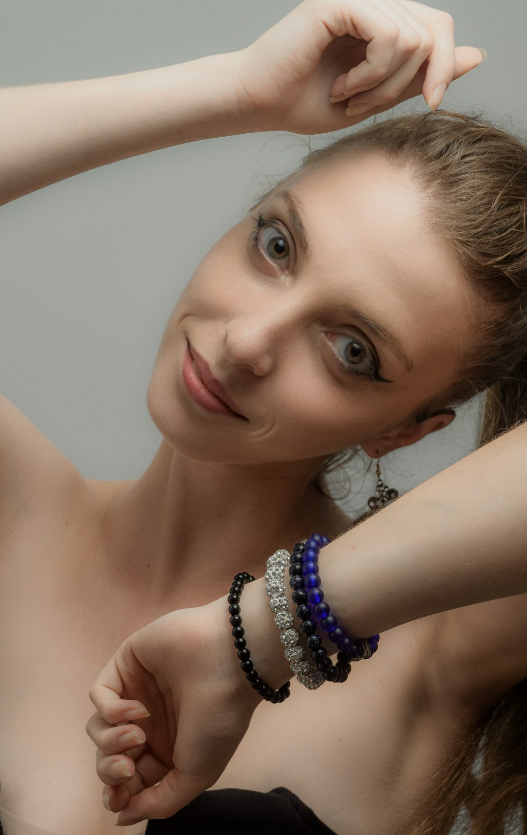 woman wearing silver and blue beaded necklace