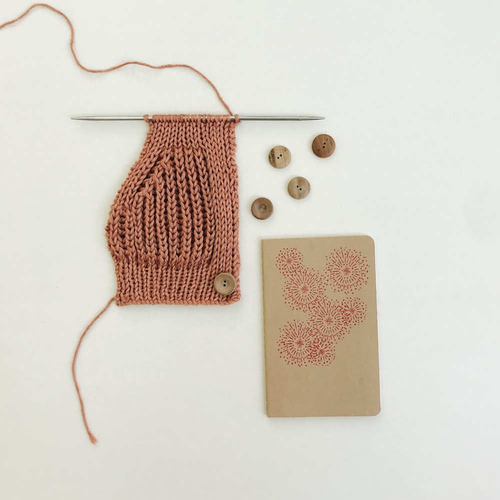 red knit sweater on white table