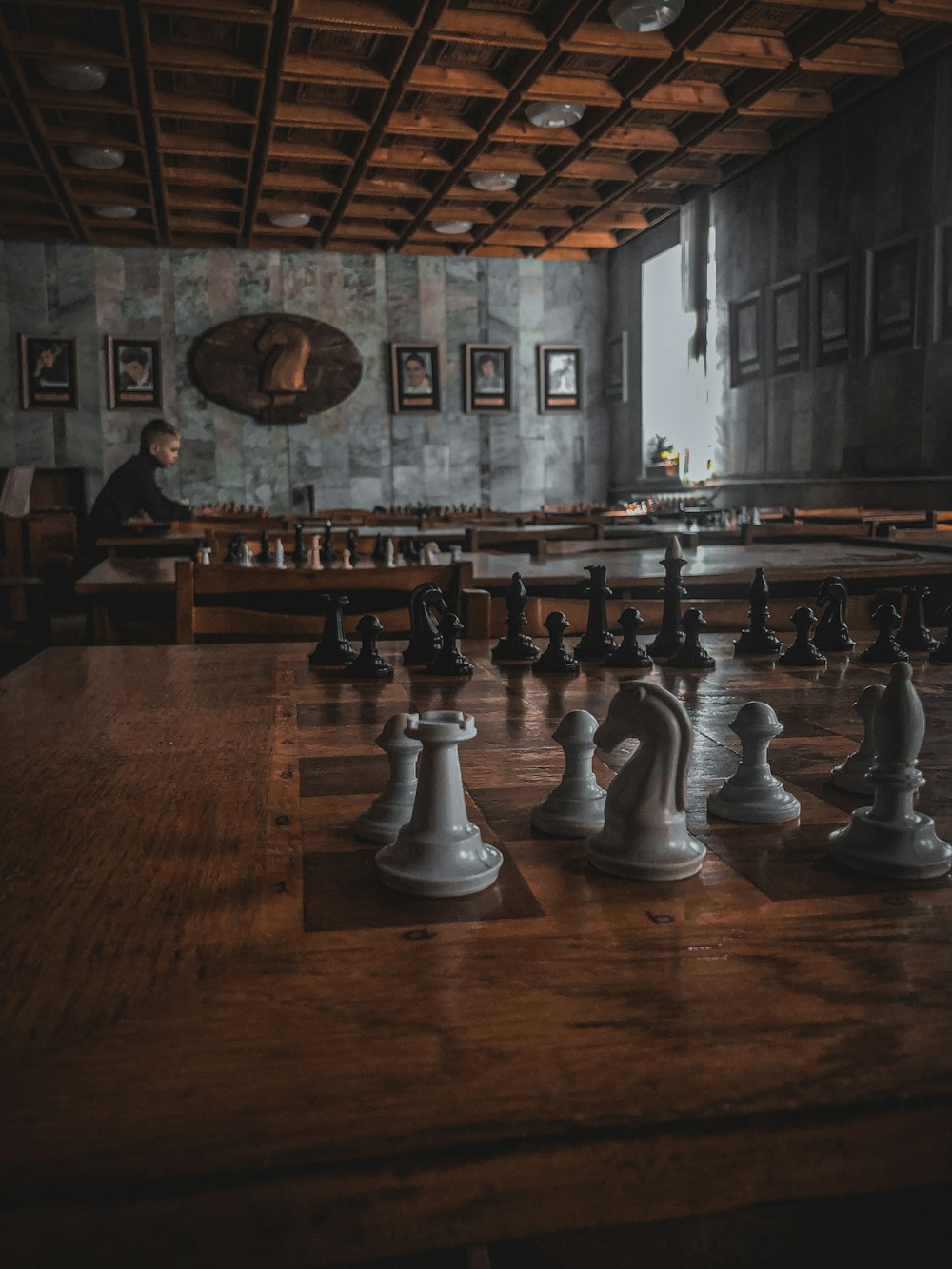 brown wooden table with chess pieces
