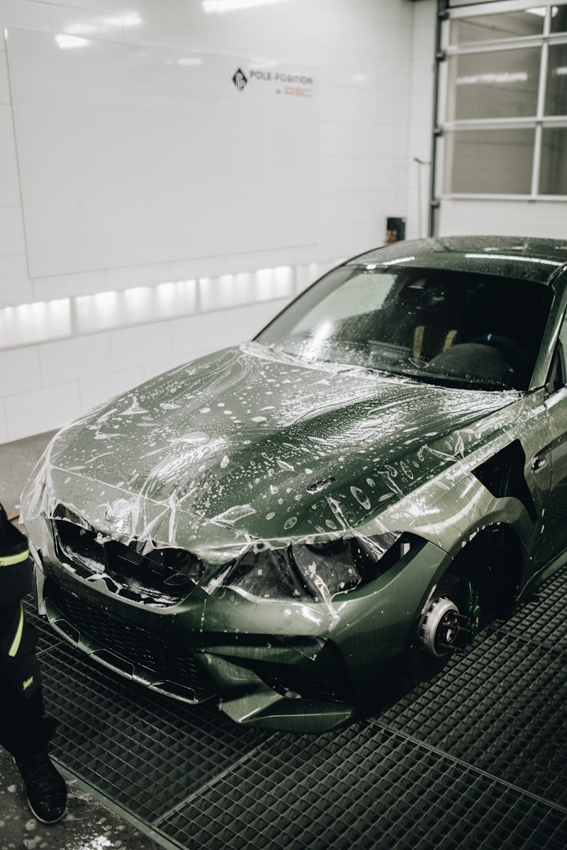 Paint protection film — clear PPF wet installation on luxury car