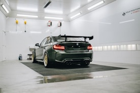 black porsche 911 parked in a parking lot