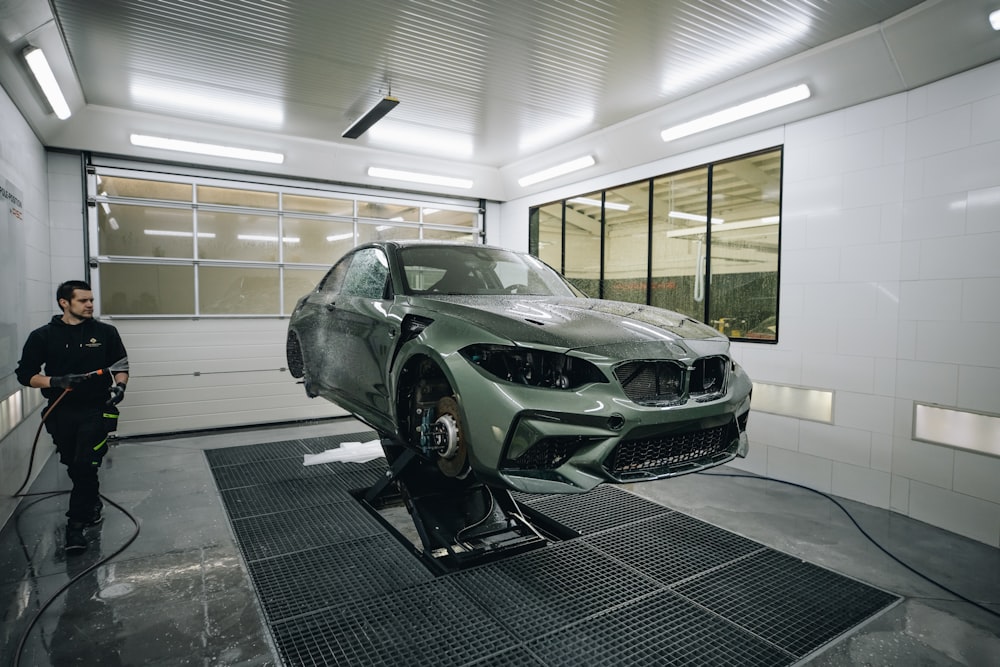 green sports car parked in garage