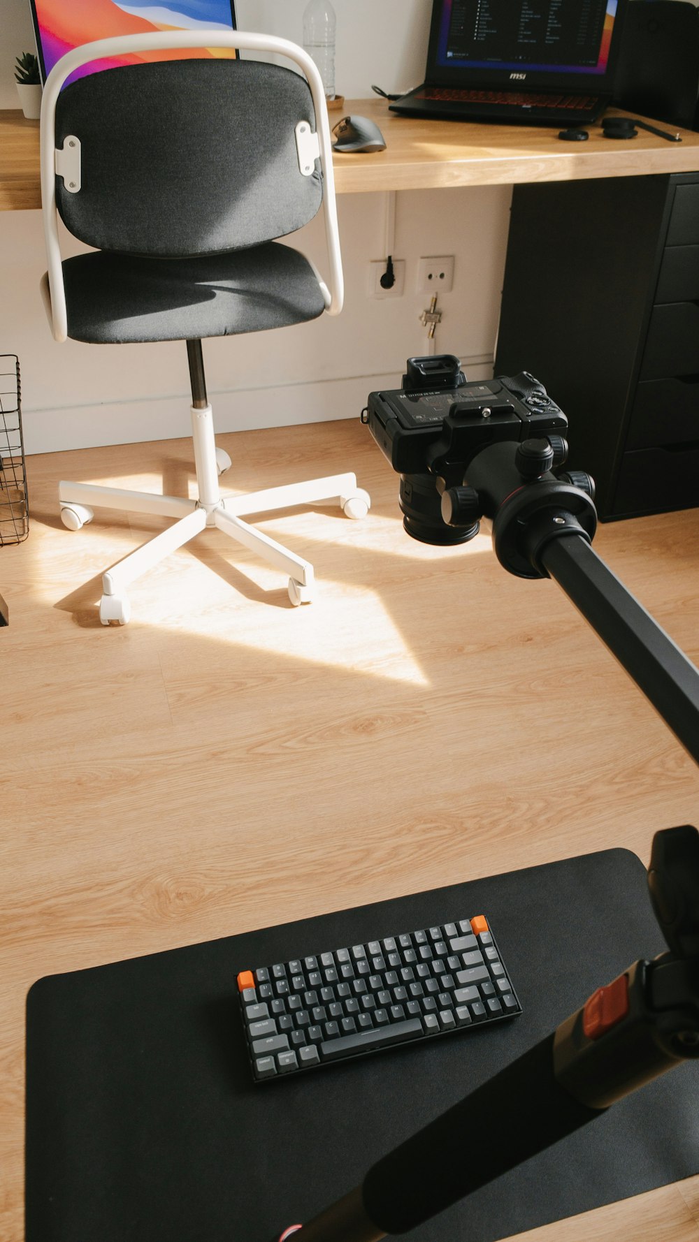 black and gray camera on brown wooden desk