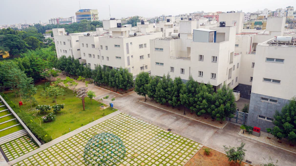 A well-maintained residential site with green spaces and security personnel on duty.