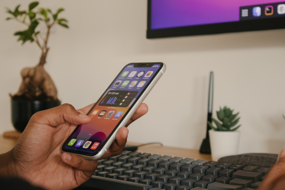 person holding silver iphone 6