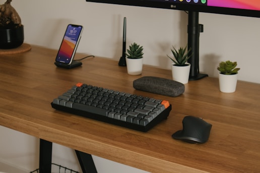 black computer keyboard on brown wooden desk