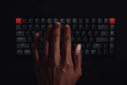 A close-up of a finger pressing a red cancel button on a keyboard.