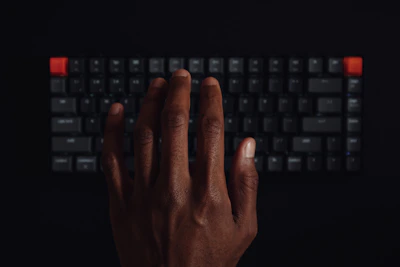 Close-up of a hand placing a guest post on a high-authority website on a computer screen.
