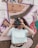 woman in white crew neck t-shirt holding black camera