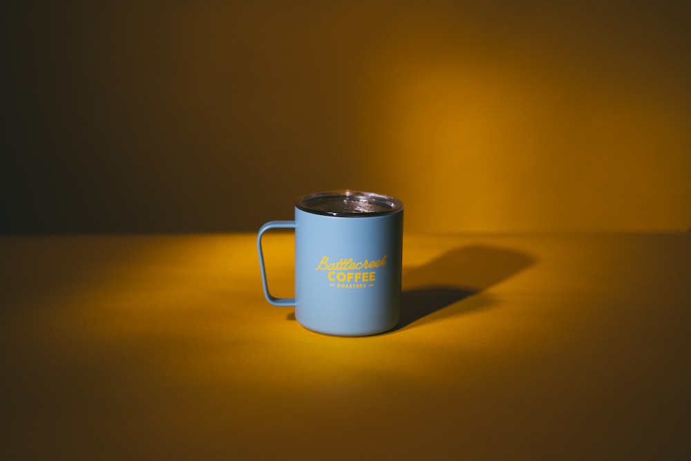 white ceramic mug on brown wooden table