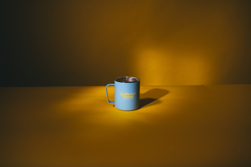white ceramic mug on yellow table