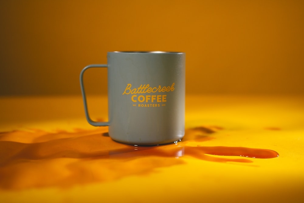 white ceramic mug on brown wooden table