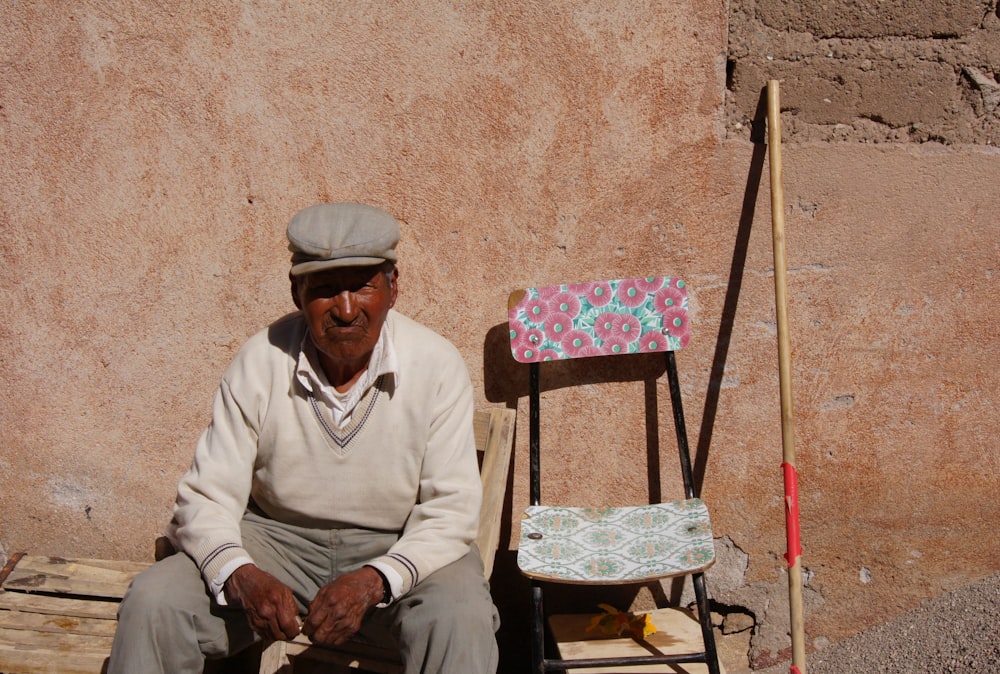 man in white long sleeve shirt sitting on folding chair