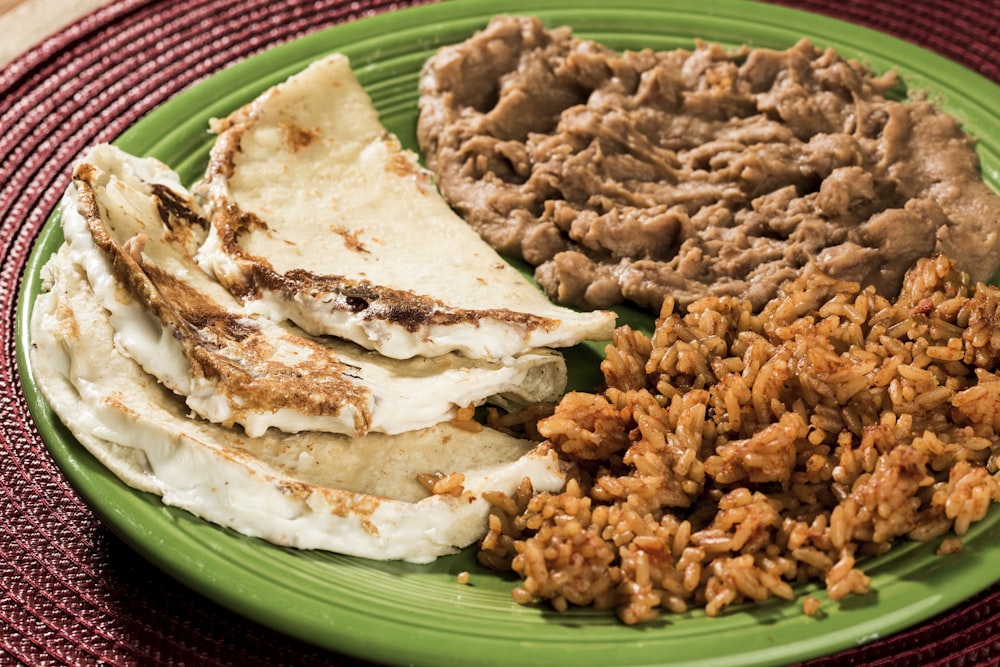 fried rice on green and white ceramic plate