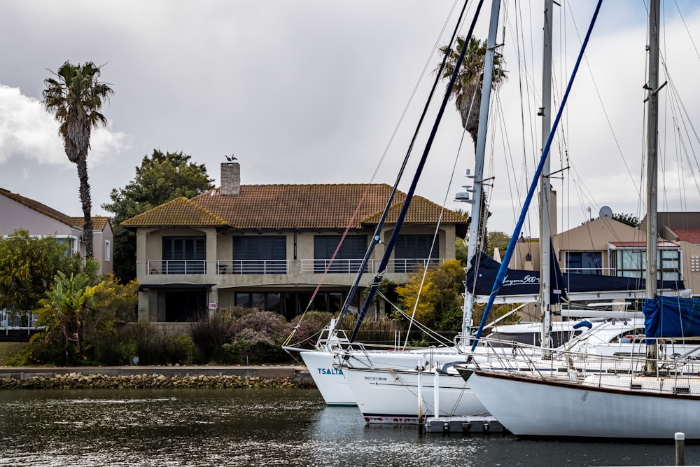 white sail boat on body of water near brown concrete building during daytime