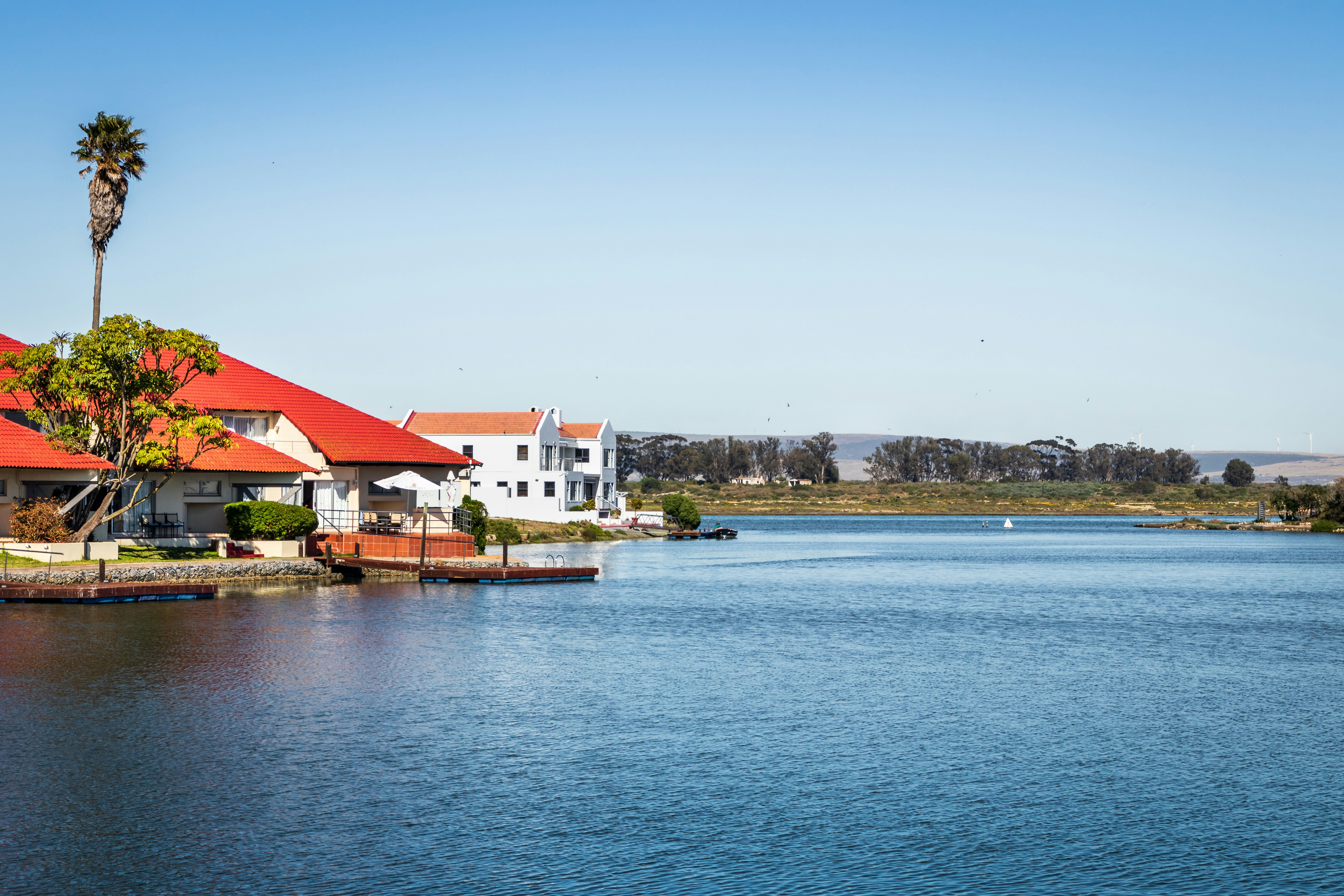 white and brown houses near body of water during daytime