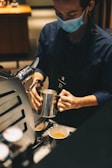A barista preparing coffee with a smile.